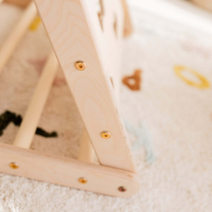 Detailansicht des Kletterdreiecks Äffchen mit Sprossen und Netz, gefertigt aus hellem Holz.